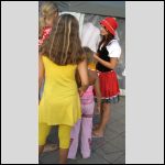 Dressed in a medieval style, another Latvian girl explains something to her visitors